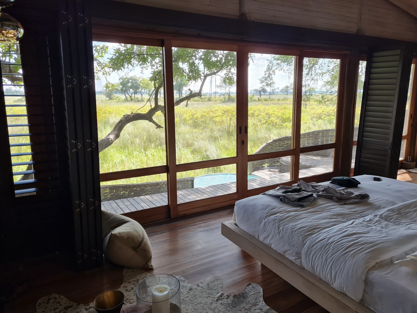 andBeyond Sandibe Okavango Safari Lodge — 12 curved-thatch suites with Nick Plewman pangolin-shell architectural register on Moremi-bordering concession