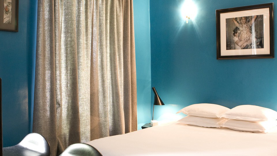 Hôtel Amour Paris room — artist-decorated with flea-market antiques, no television, intimate 9th arrondissement boutique