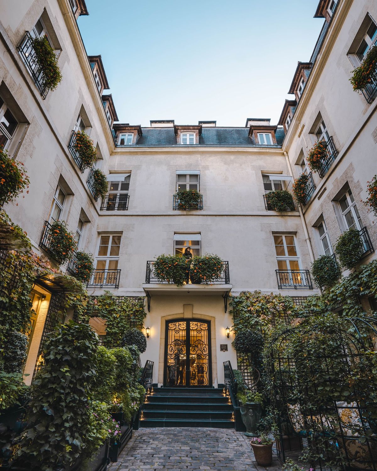 Relais Christine Paris — intimate 16th-century abbey suite with canopy bed and exposed stone walls in Saint-Germain-des-Prés